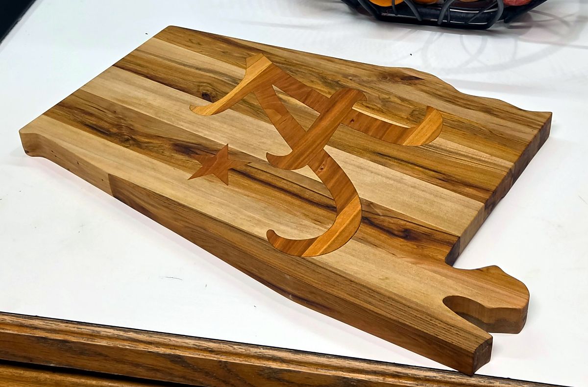 Alabama-shaped cutting board with an inlaid letter and star